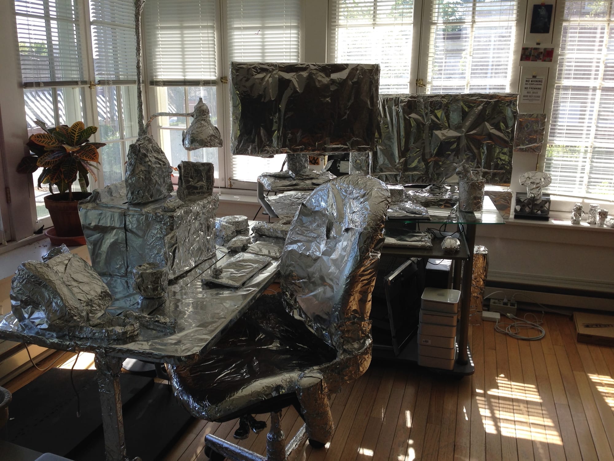 Jake’s office desk, chair, computer and everything on it wrapped in aluminum foil by his coworkers